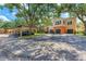 Condo exterior with covered parking and colorful two-story buildings at 4110 Central Sarasota Pkwy # 123, Sarasota, FL 34238