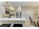 Modern kitchen features a breakfast bar with quartz countertops and stainless steel appliances at 4110 Central Sarasota Pkwy # 123, Sarasota, FL 34238
