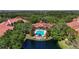 Stunning aerial view of a community pool with mature trees and lush landscaping, offering a tranquil oasis at 4110 Central Sarasota Pkwy # 123, Sarasota, FL 34238