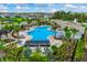 Aerial view of the community pool, clubhouse, cabanas, with lush landscaping, surrounded by homes at 4231 Autumn Fog Ct, Palmetto, FL 34221