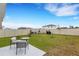 Large backyard with a patio, lawn, and privacy fence provides space for outdoor activities at 4231 Autumn Fog Ct, Palmetto, FL 34221