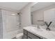 Clean bathroom with a shower-tub combo, white marble countertop, and dark gray vanity at 4231 Autumn Fog Ct, Palmetto, FL 34221