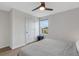 Bright bedroom featuring a ceiling fan, a window with blinds, and light hardwood floors at 4231 Autumn Fog Ct, Palmetto, FL 34221