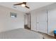 Comfortable bedroom with gray quilt, modern ceiling fan, access to an ensuite, and hardwood floors at 4231 Autumn Fog Ct, Palmetto, FL 34221