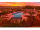 Aerial view of community pool area with palm trees and sunset at 4231 Autumn Fog Ct, Palmetto, FL 34221
