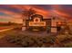 Elegant community sign featuring a water feature and manicured landscaping at sunset at 4231 Autumn Fog Ct, Palmetto, FL 34221