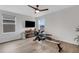 Well-lit exercise room equipped with a rowing machine, modern ceiling fan, and ample natural light at 4231 Autumn Fog Ct, Palmetto, FL 34221
