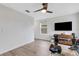 Modern exercise room featuring a large flat screen TV, rowing machine, and a modern ceiling fan at 4231 Autumn Fog Ct, Palmetto, FL 34221