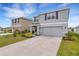 Two-story home with a concrete driveway, attached two-car garage, and neutral exterior paint at 4231 Autumn Fog Ct, Palmetto, FL 34221