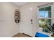 Bright entryway features a side window, a blue bench, and stylish decor at 4231 Autumn Fog Ct, Palmetto, FL 34221