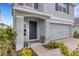 Inviting entryway with gray paint, a 'no soliciting' sign, and colorful landscaping at 4231 Autumn Fog Ct, Palmetto, FL 34221