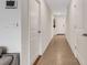 Hallway featuring neutral walls and floors, and multiple access doors at 4231 Autumn Fog Ct, Palmetto, FL 34221