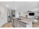 Open kitchen island features granite countertops and stainless steel appliances overlooking the living area at 4231 Autumn Fog Ct, Palmetto, FL 34221