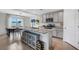 Modern kitchen with an island, a wine rack, granite countertops, and stainless steel appliances at 4231 Autumn Fog Ct, Palmetto, FL 34221