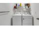 Functional laundry room with side-by-side washer and dryer units and overhead storage at 4231 Autumn Fog Ct, Palmetto, FL 34221