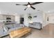 Open-concept living area with tile flooring, ceiling fan, comfortable seating, and views into the modern kitchen at 4231 Autumn Fog Ct, Palmetto, FL 34221