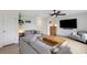 Stylish living room featuring modern decor, tile floors, ample seating, and a mounted flat screen television at 4231 Autumn Fog Ct, Palmetto, FL 34221