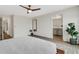 Clean main bedroom design with ensuite bathroom access, light walls, and modern ceiling fan at 4231 Autumn Fog Ct, Palmetto, FL 34221