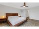 Comfortable main bedroom showcasing a wooden bed frame, lamps, and a patterned rug at 4231 Autumn Fog Ct, Palmetto, FL 34221