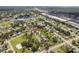 Wide aerial view of the home's location within a residential neighborhood with nearby commercial areas at 4493 Mckibben Dr, North Port, FL 34287