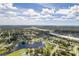 An aerial shot displays a community situated near a lake, with lush green landscaping at 4493 Mckibben Dr, North Port, FL 34287