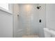 Beautiful renovated bathroom with walk-in shower, gray tiling, and unique mosaic accent at 4493 Mckibben Dr, North Port, FL 34287