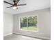 Bedroom featuring neutral paint, ceiling fan, and a view to the backyard at 4493 Mckibben Dr, North Port, FL 34287