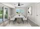 Bright dining room with contemporary table, stylish chairs, and sliding door access to the backyard at 4493 Mckibben Dr, North Port, FL 34287