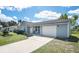 Inviting home featuring a one-car garage, cozy front patio, and well-maintained lawn at 4493 Mckibben Dr, North Port, FL 34287