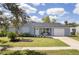 Charming single-story home with well-manicured lawn, tidy landscaping, and inviting front porch at 4493 Mckibben Dr, North Port, FL 34287