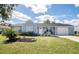 Charming one-story home with a well-manicured lawn and inviting curb appeal on a sunny day at 4493 Mckibben Dr, North Port, FL 34287