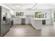 Modern kitchen featuring stainless steel appliances, white cabinetry, and a stylish subway tile backsplash at 4493 Mckibben Dr, North Port, FL 34287