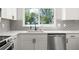 Close up of updated kitchen with sleek countertops, stainless steel appliances, and modern subway tile backsplash at 4493 Mckibben Dr, North Port, FL 34287