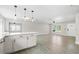 Bright, open-concept living room with modern lighting and tile flooring at 4493 Mckibben Dr, North Port, FL 34287