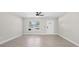 Bright, open-concept living room with a ceiling fan and tiled floors at 4493 Mckibben Dr, North Port, FL 34287