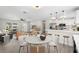 Inviting open-concept area featuring dining table adjacent to the living area and modern kitchen with counter seating at 4493 Mckibben Dr, North Port, FL 34287