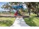 A neighborhood playground features a colorful playset with slides and swings for children to enjoy at 4493 Mckibben Dr, North Port, FL 34287