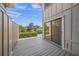 Cozy outdoor deck with sliding door, offering serene views of the lake and surrounding landscape at 4543 Forest Wood Trl # 33, Sarasota, FL 34241