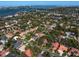 An aerial view shows the property nestled in a tree-filled neighborhood near the water at 4701 Pine Harrier Dr, Sarasota, FL 34231