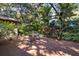Outdoor patio featuring brick flooring and outdoor dining set with lush landscaping at 4701 Pine Harrier Dr, Sarasota, FL 34231