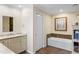 Bright bathroom featuring a bathtub with tiled backsplash, and a vanity with a marble countertop at 4701 Pine Harrier Dr, Sarasota, FL 34231