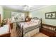 Comfortable bedroom featuring a charming quilt, wooden bench and shuttered windows at 4701 Pine Harrier Dr, Sarasota, FL 34231
