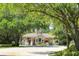 A welcoming community entrance with lush landscaping and a charming guardhouse, offering security and curb appeal at 4701 Pine Harrier Dr, Sarasota, FL 34231