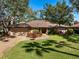 Charming single-story home with a tile roof, mature trees and a well-manicured lawn and a two car garage at 4701 Pine Harrier Dr, Sarasota, FL 34231
