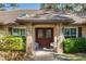 Inviting double-door entry with brick accents, elegant lighting, and seating for guests at 4701 Pine Harrier Dr, Sarasota, FL 34231
