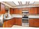 Cherry wood kitchen offers stainless appliances, sleek countertops and ample storage at 4701 Pine Harrier Dr, Sarasota, FL 34231