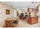 Inviting dining and living area featuring hardwood floors, floral wallpaper, and cozy fireplace at 4701 Pine Harrier Dr, Sarasota, FL 34231