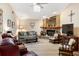 Cozy living room with brick fireplace, wood floors, and a ceiling fan at 4701 Pine Harrier Dr, Sarasota, FL 34231