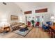 Bright living room with wood floors, high ceilings, and large French doors for natural light at 4701 Pine Harrier Dr, Sarasota, FL 34231