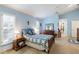 Bright bedroom with plush carpet, plantation shutters and blue walls at 4701 Pine Harrier Dr, Sarasota, FL 34231